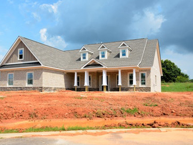grey house under blue sky