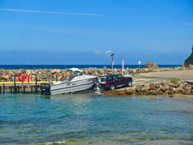 person launching boat into water