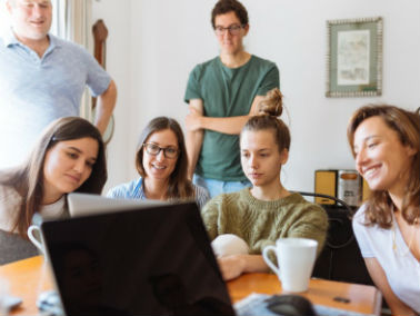 family sitting together looking at a document