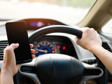 driver holding smartphone while driving
