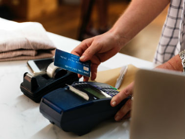 Blue credit card being used while shopping