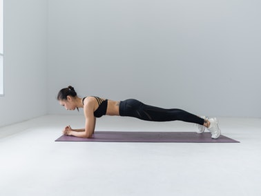 woman planking on yoga mat