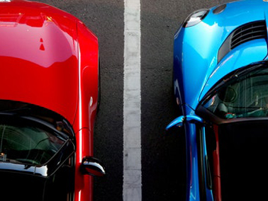 two cars next to each other in a parking lot