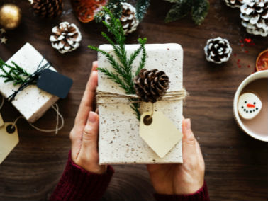 Christmas present decorated with pine around it