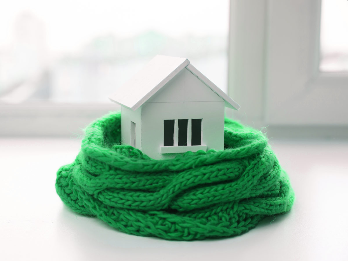 A model of a house with a scarf wrapped around it