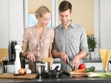 couple preparing a meal in kitchen together