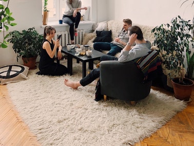 friends sitting on a shag rug and couch