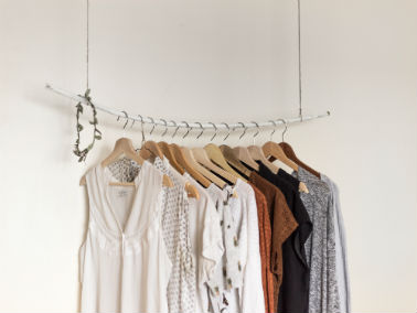 clothes hanging from wooden hangers