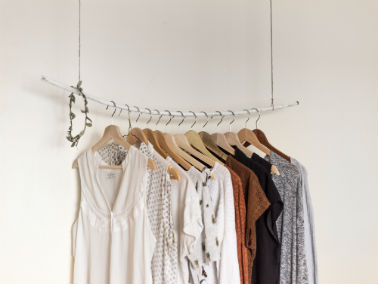 clothes hanging from wooden hangers