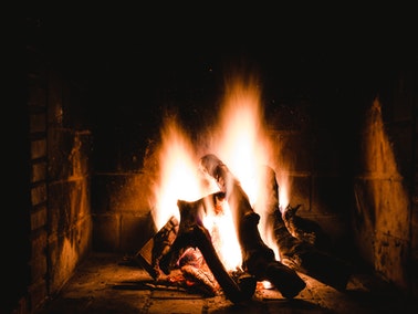 roaring fire in dark fireplace