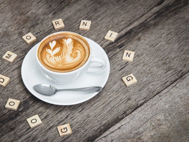 coffee mug surrounded by scrabble letters spelling out good morning