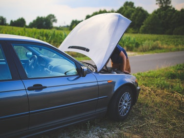 man repairing vehicle