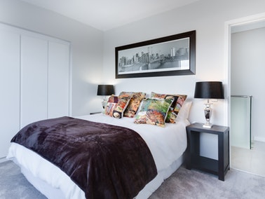 bedroom with a blanket draped on the bed