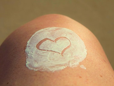 white heart shape of sunscreen on person