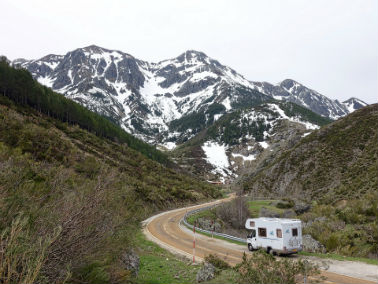 RV with snow-covered mountains in the background