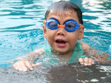 a boy wearing goggles and swimming