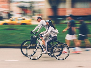 two people bike riding in the city