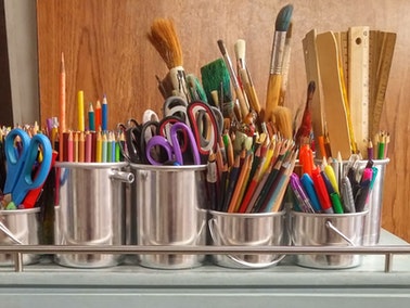 school supplies neatly organized in silver buckets