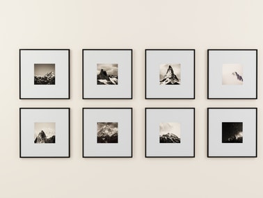 assorted black and white photographs on neutral wall