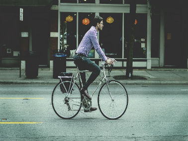 man riding bike in the city