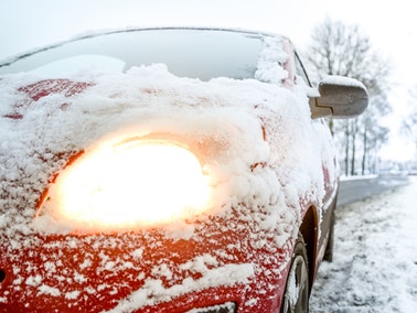 red car covered with snow