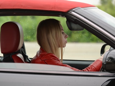 woman leaning forward in driver’s seat