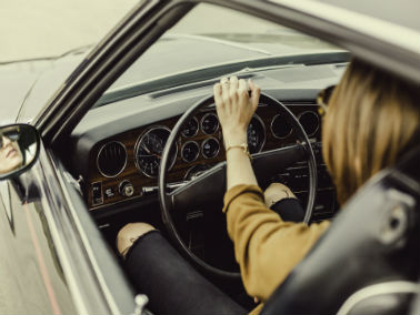 woman driving vintage car