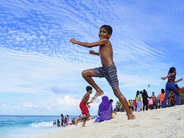 Boy jumping on the beach
